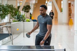 UConn student playing pingpong.