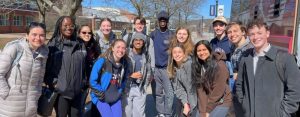 Fourteen students gathered together smiling for the camera